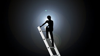 Silhouette of man climbing ladder reaching for light bulb