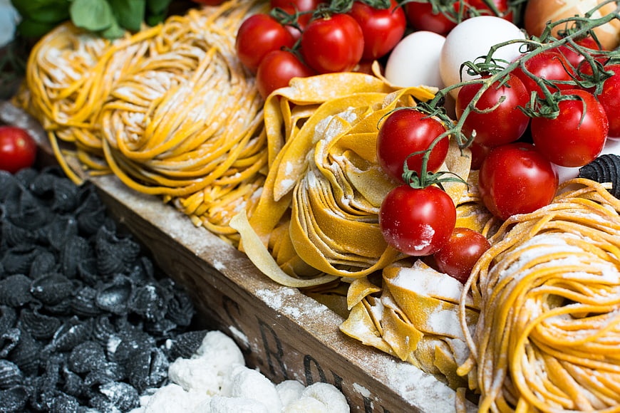 Fresh Italian pasta nests with cherry tomatoes and eggs