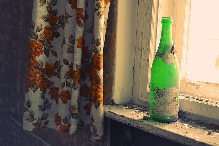 Vintage Green Glass Bottle on Weathered Windowsill