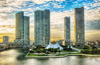 Miami skyline with skyscrapers and white tents at sunset