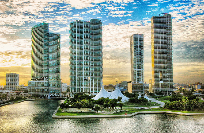 Miami skyline with skyscrapers and white tents at sunset