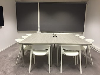 Modern Empty Conference Room with Wooden Table and White Chairs