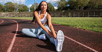 Athletic Woman Stretching on Outdoor Running Track