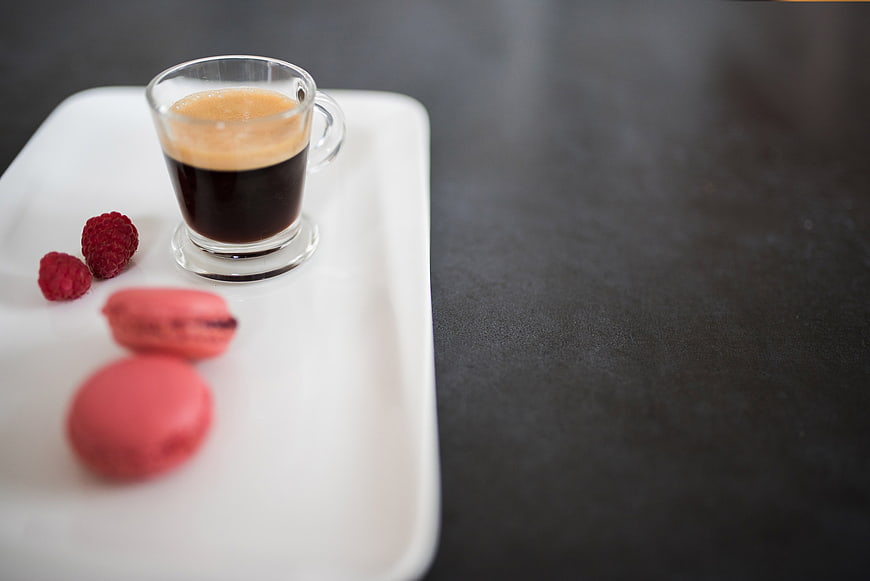 Espresso with Macarons and Raspberries on White Tray