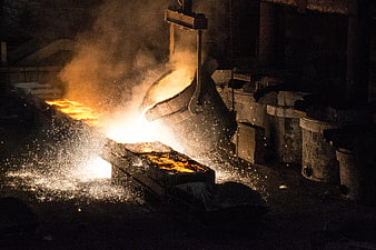 Molten metal pouring in industrial steel foundry