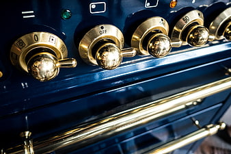 Close-up of vintage blue oven with brass knobs