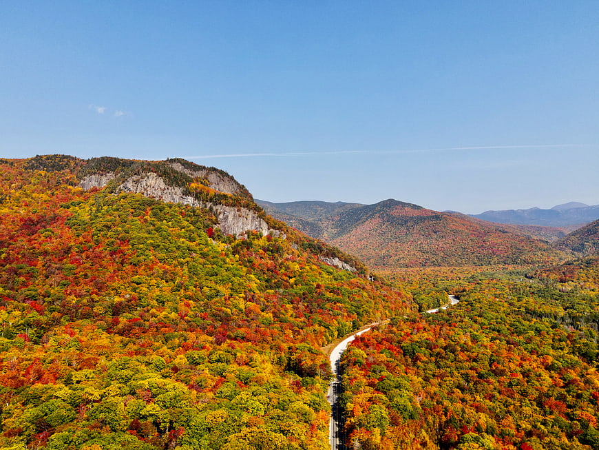 Aerial View of Vibrant Autumn Mountains and Winding Road