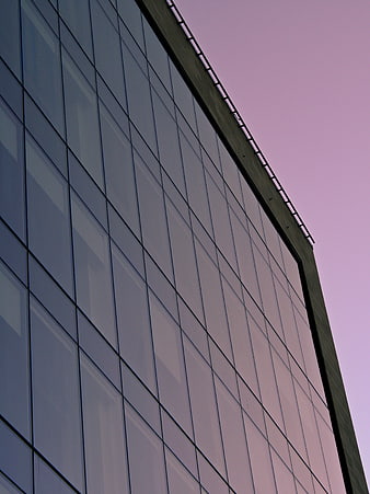 Modern Glass Office Building Facade Against Pink Sky
