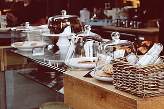 Pastries and cookies under glass domes in a cozy cafe