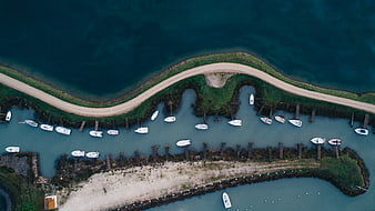 Aerial View of Curved Marina with White Boats