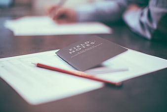 Field Notes Notebook and Pencil on Desk with Blurred Background