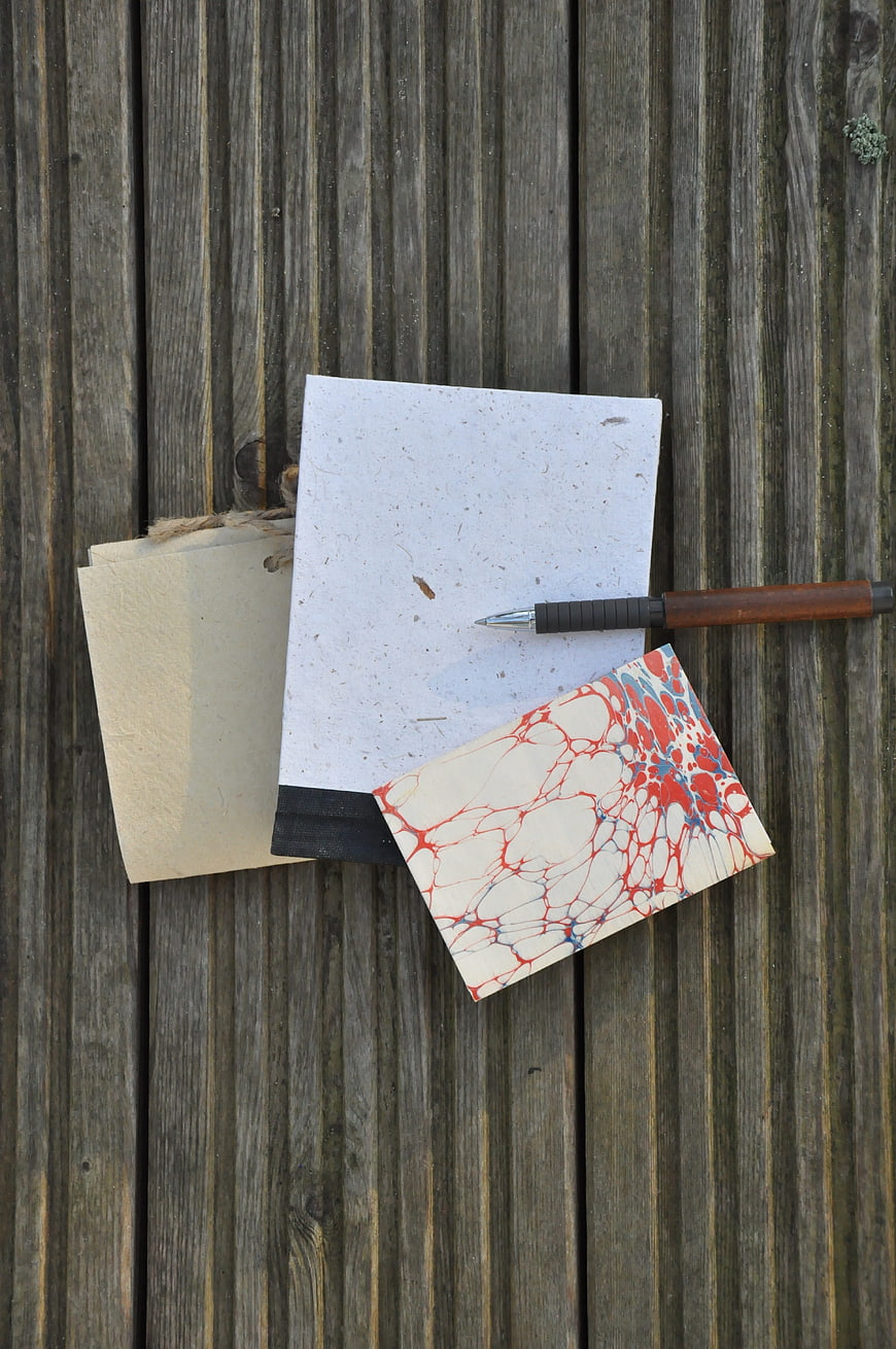 Stationery and pen on rustic wooden background