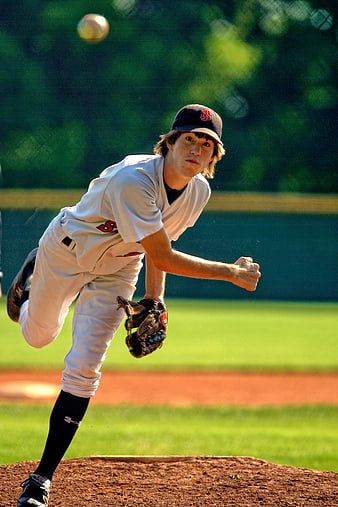 Young Baseball Pitcher Throwing Ball on Field