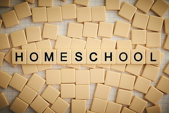 Homeschool spelled with letter tiles on graph paper