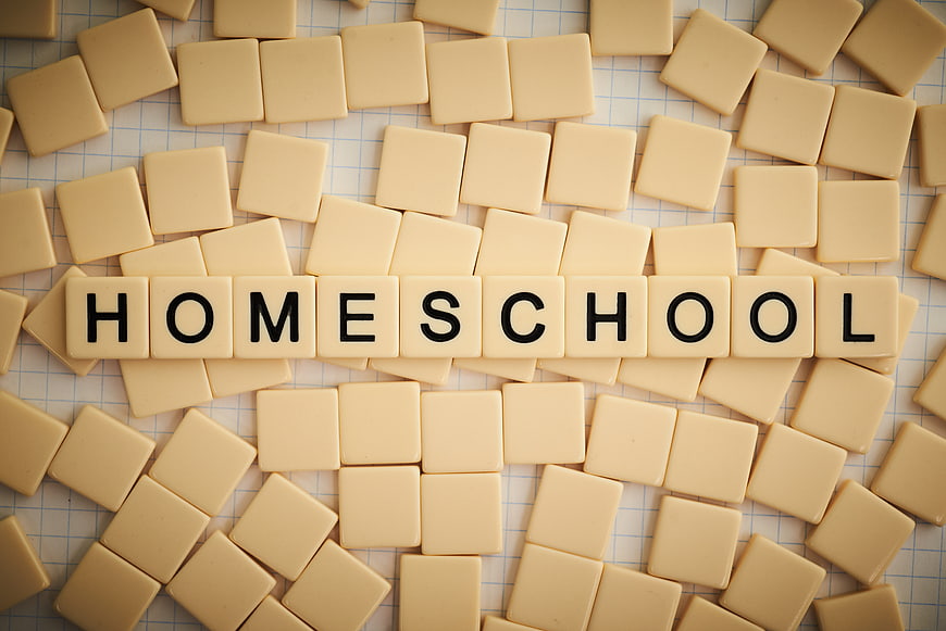 Homeschool spelled with letter tiles on graph paper