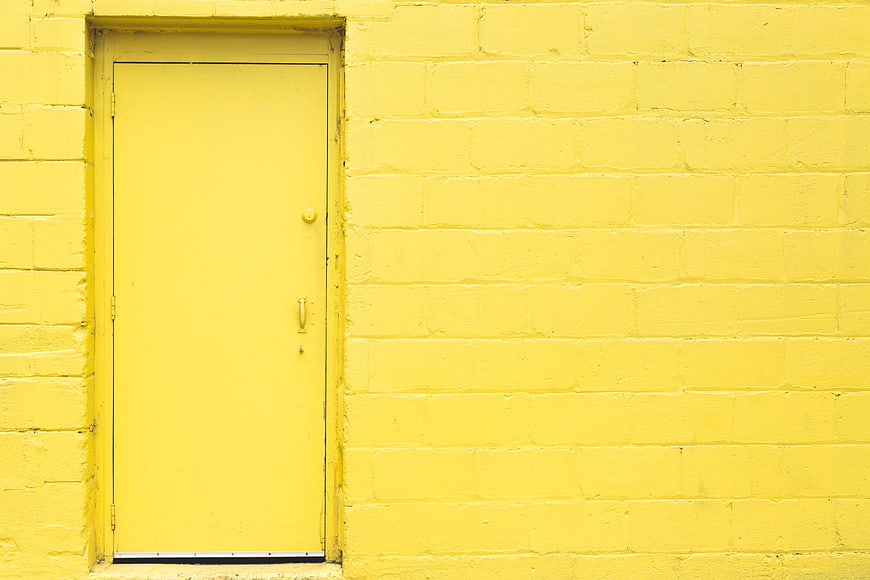 Minimalist Yellow Brick Wall with Closed Door