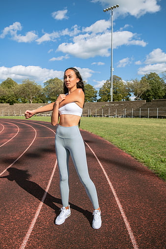 Female Athlete Stretching on Outdoor Running Track