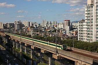 Green and Cream Subway Train on Elevated Tracks in Seoul