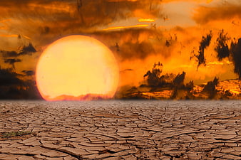 Dramatic Sunset Over Cracked Dry Earth Landscape