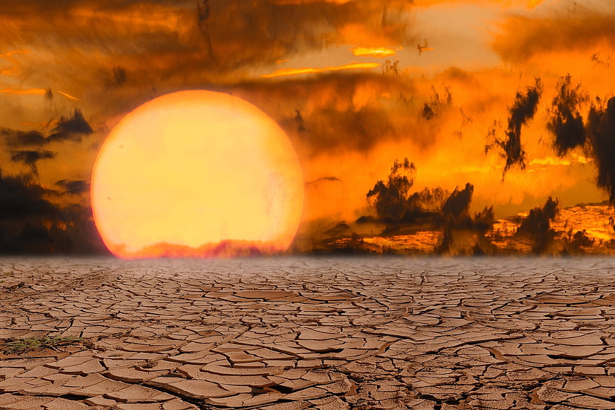 Dramatic Sunset Over Cracked Dry Earth Landscape