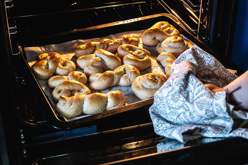 Homemade braided bread rolls baking in oven
