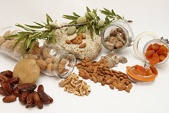 Assortment of dried fruits and nuts on white background