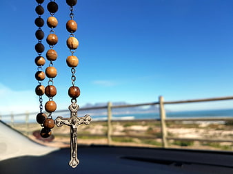 Wooden Rosary Hanging in Car with Ocean View