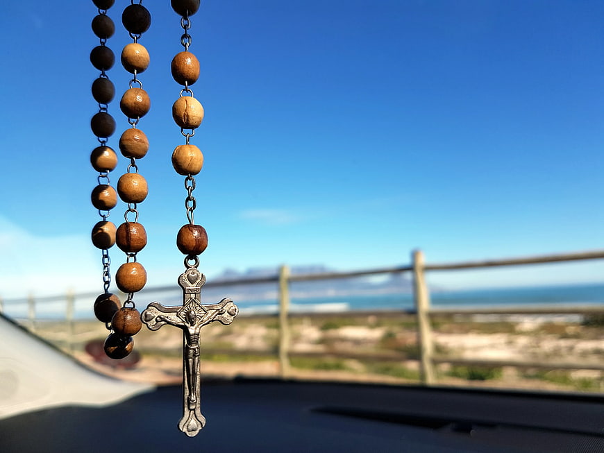 Wooden Rosary Hanging in Car with Ocean View