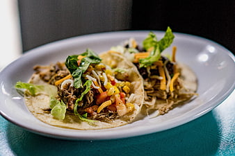 Two Mexican Tacos with Meat and Fresh Toppings on White Plate