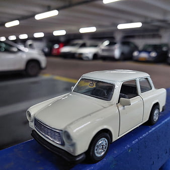 White Trabant toy car model in parking garage