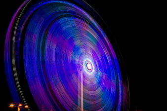 Abstract purple and blue light trails on black background