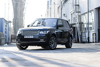 Black Range Rover SUV Parked In Industrial Urban Setting