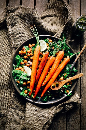 Overhead view of roasted carrots and chickpea salad on rustic wood