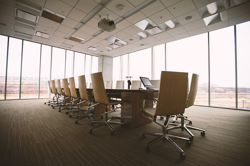 Modern Empty Conference Room with Large Windows and Wooden Chairs