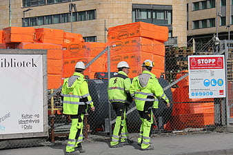 Construction Workers in High-Visibility Gear at Urban Site