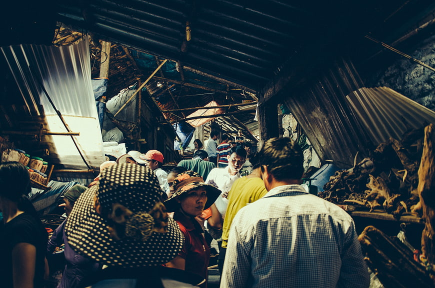 Crowded Local Market Scene with Shoppers and Vendors