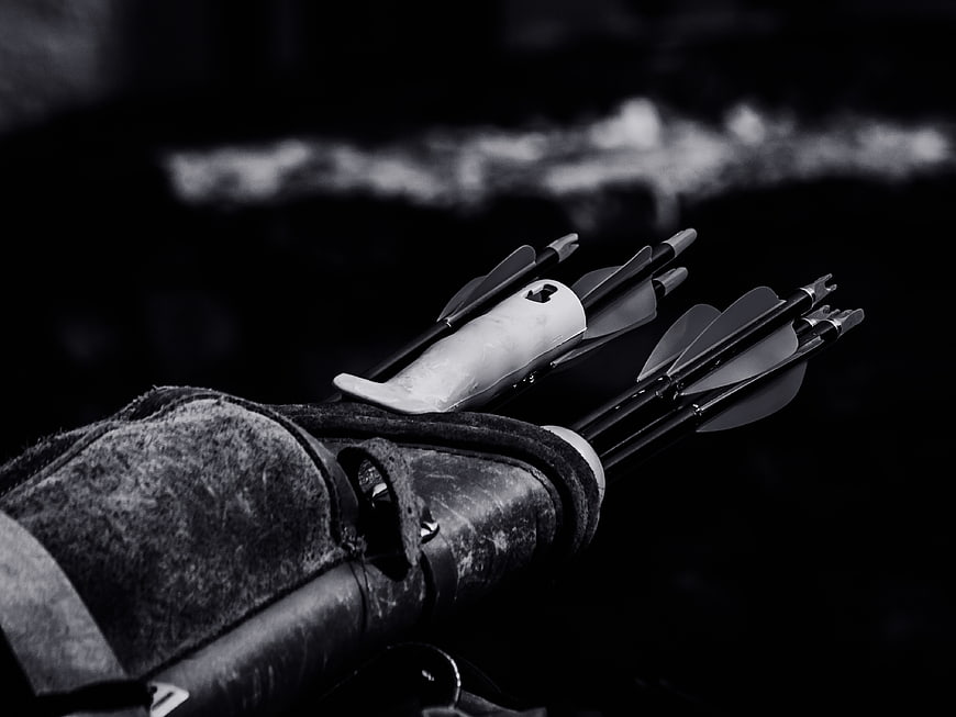 Close-up of leather quiver with arrows in black and white