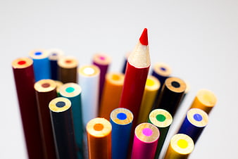 Sharp Red Pencil Standing Out Among Blurred Colored Pencils