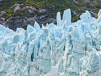 Majestic Blue Glacier Ice Formations Against Rocky Mountain Slope