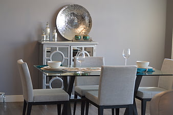 Modern dining room with glass table and gray chairs