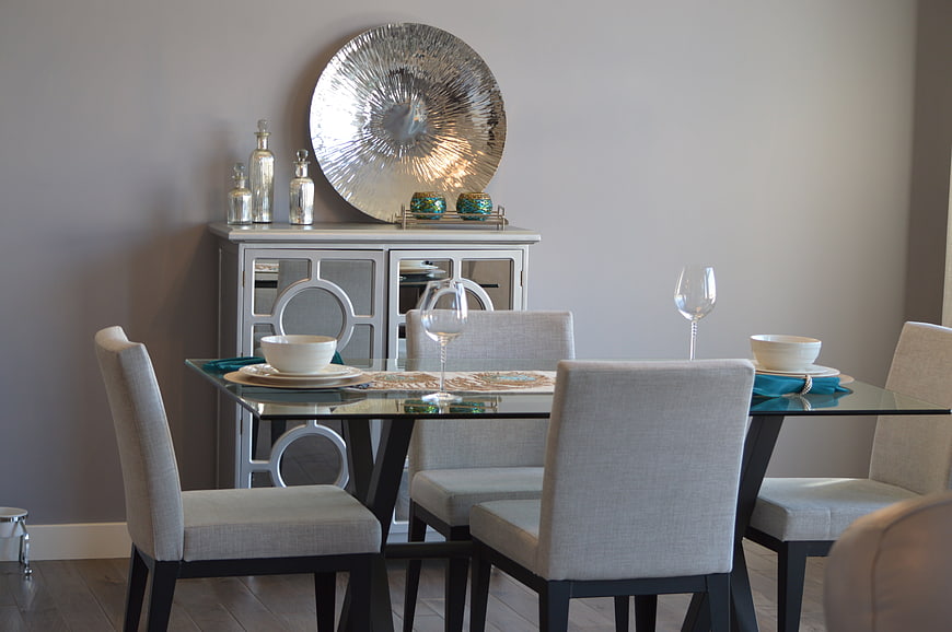 Modern dining room with glass table and gray chairs