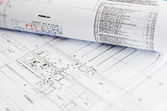 Close-up of rolled architectural blueprints and technical drawings