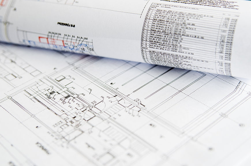 Close-up of rolled architectural blueprints and technical drawings