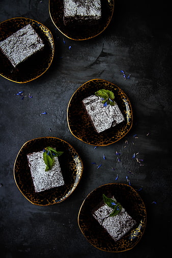 Top View of Chocolate Cake Slices on Black Gold Plates