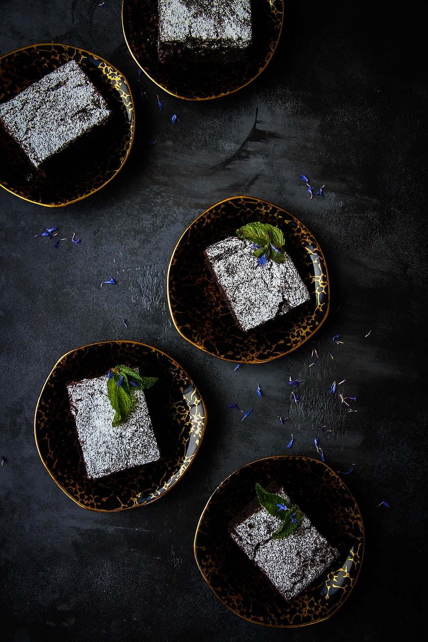 Top View of Chocolate Cake Slices on Black Gold Plates