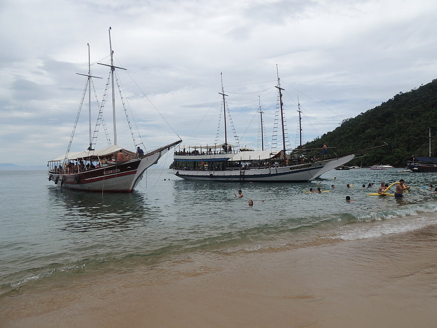 Traditional sailing schooners anchored near tropical beach