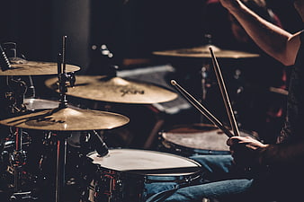 Musician Playing Drum Set in Dark Studio