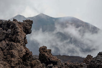 Volcanic Rock Foreground With Misty Mountain Landscape