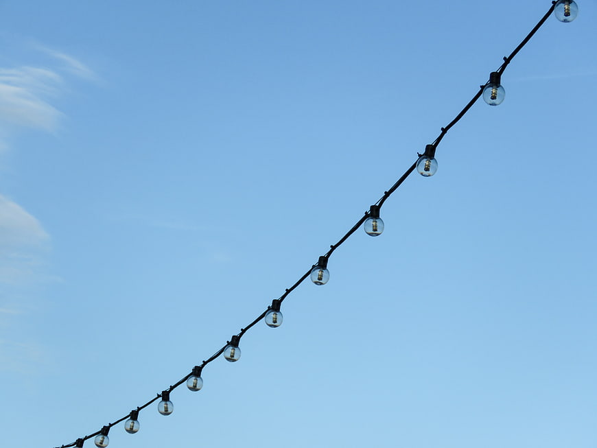 String lights against a clear blue sky background