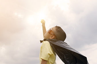 Young Boy in Superhero Cape Looking at Solar Eclipse